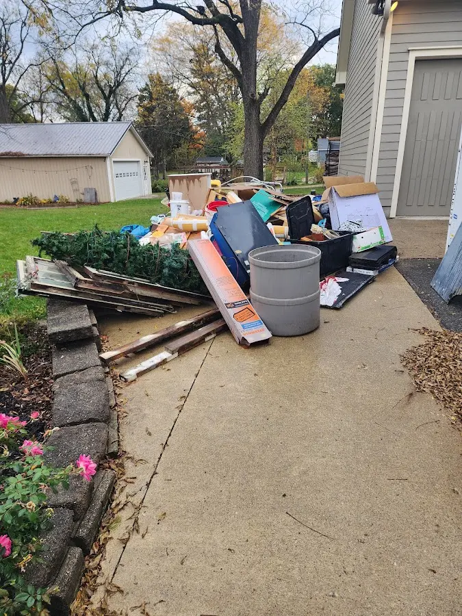 Dumpster being loaded with debris for Estate Cleanout Dumpster Rental in Goldenrod